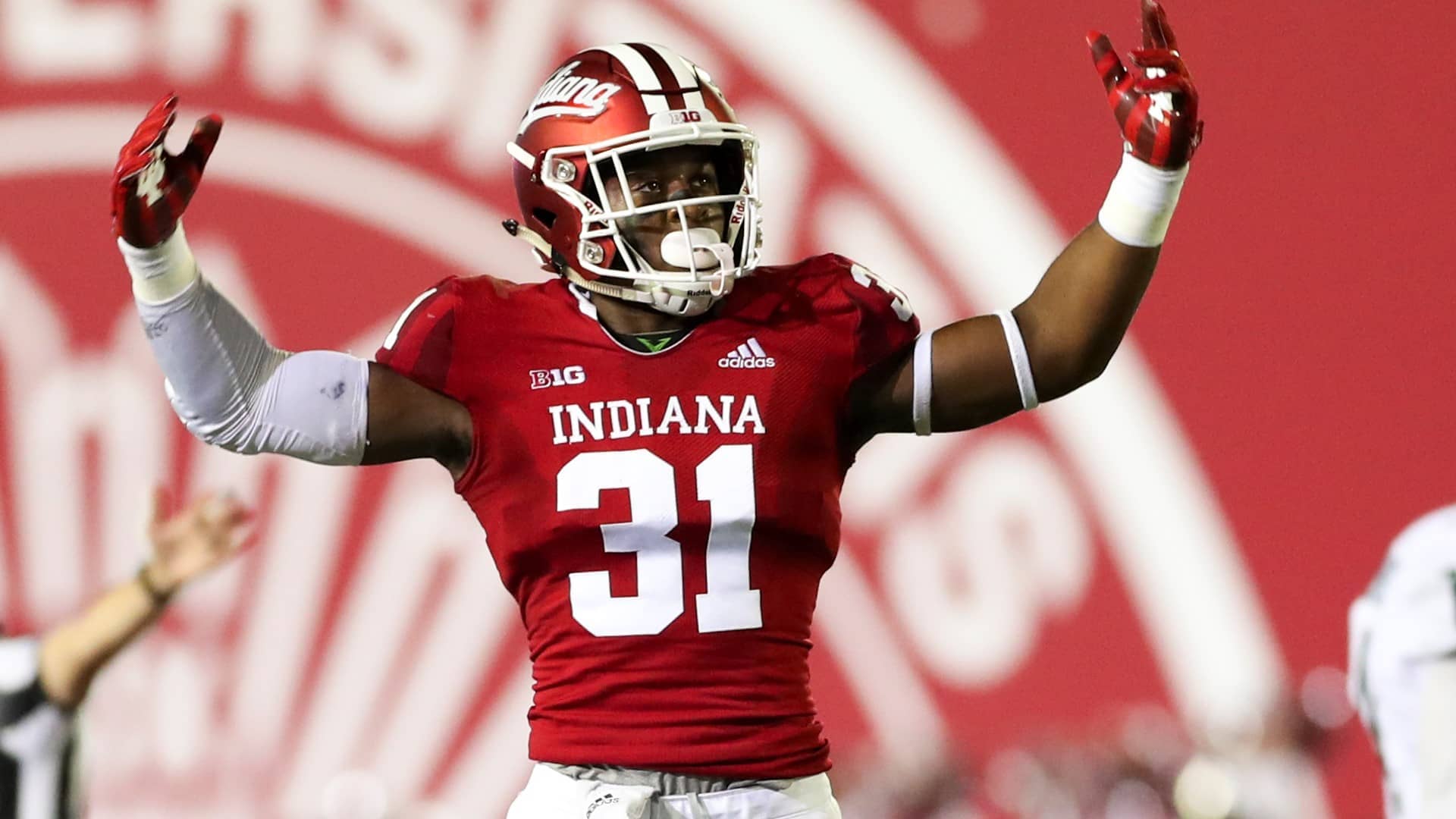 Indiana Hoosiers football player raising hands to hype up crowd