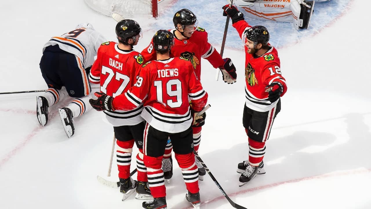 Four Chicago Blackhawks players celebrating after a goal